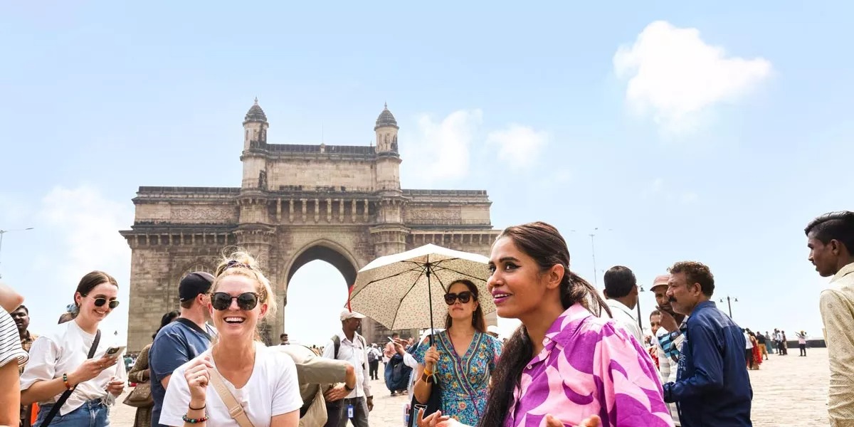 A group of people enjoying a tour around a city in India.