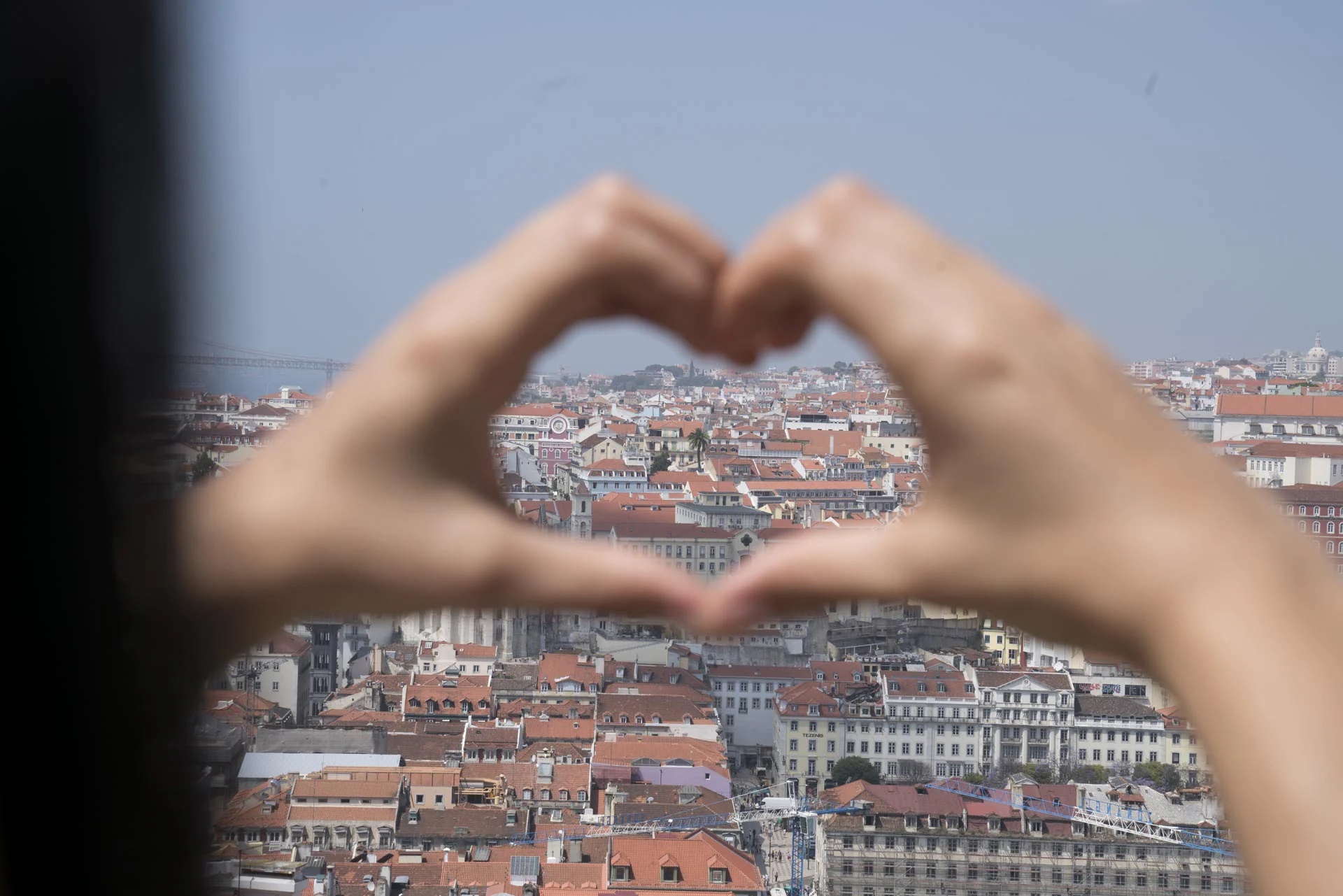 Panorama of Porto in Portugal seen through heart shape formed with hands