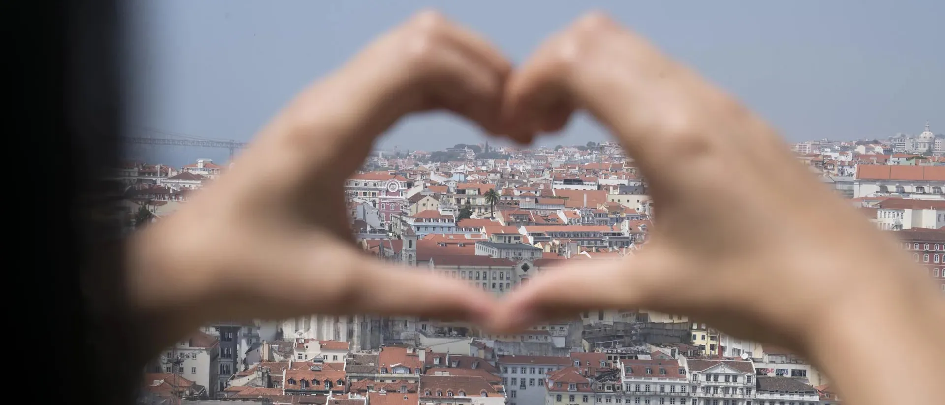 Panorama of Porto in Portugal seen through heart shape formed with hands