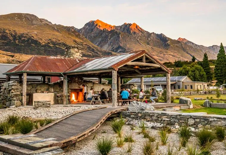 People sitting by the fire on the porch