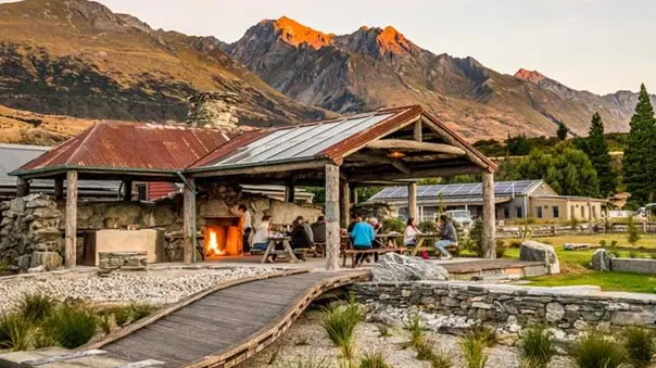 People sitting by the fire on the porch