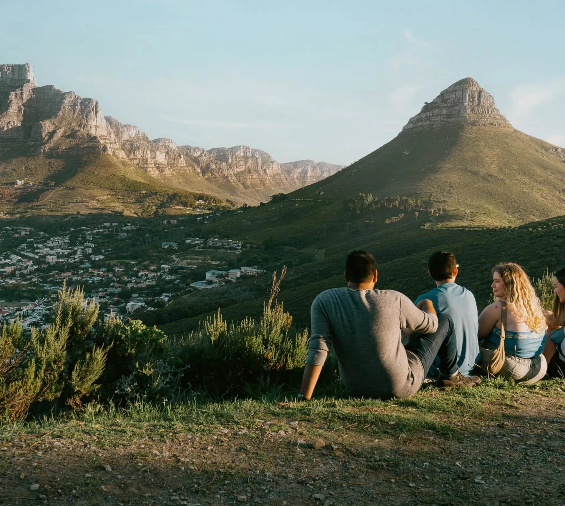 Travellers enjoy panoramic views of Table Mountain and Lion's Head overlooking Cape Town on the Contiki Cape Town, Safari & Falls Tour