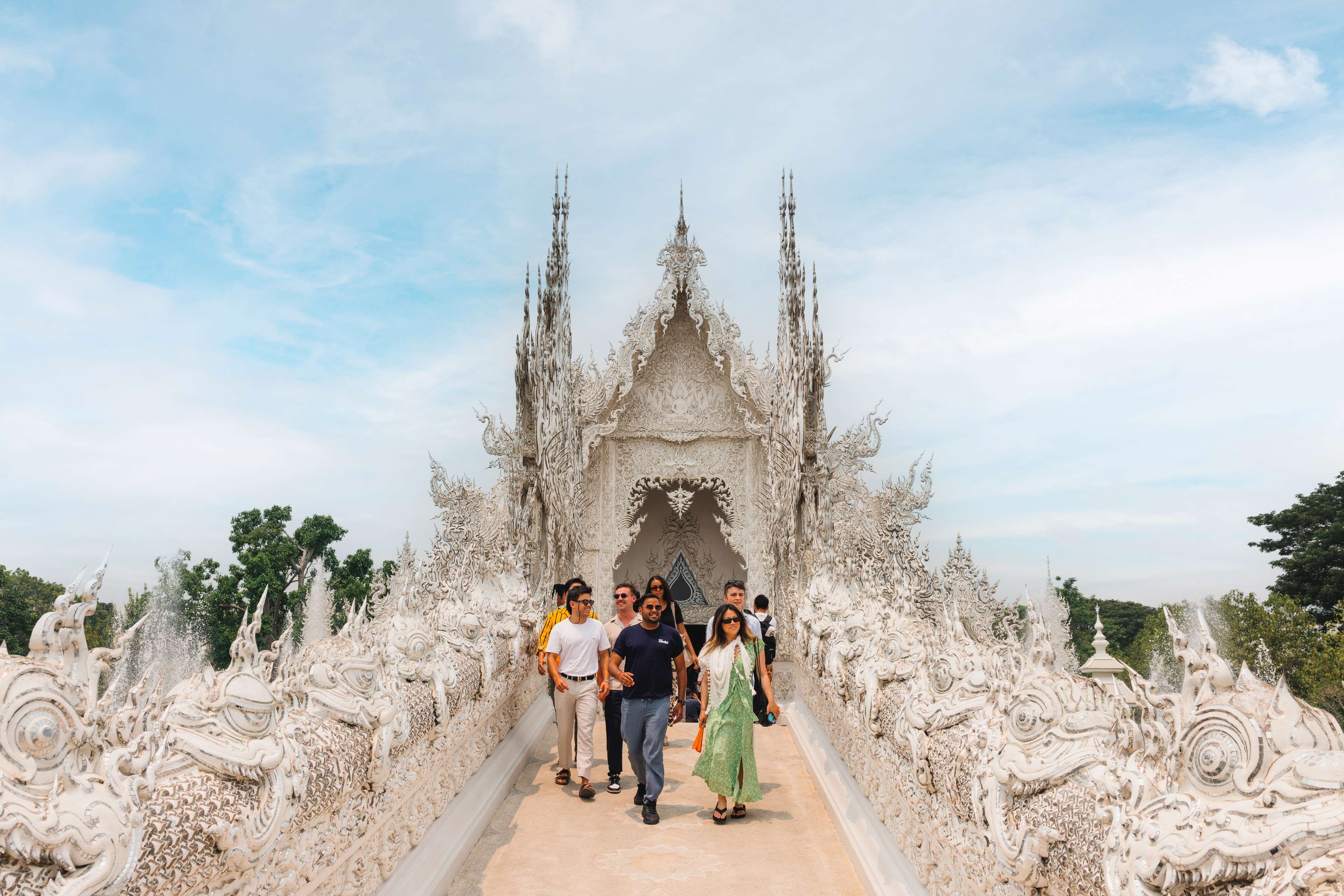 Group Walking Through Thai Temple
