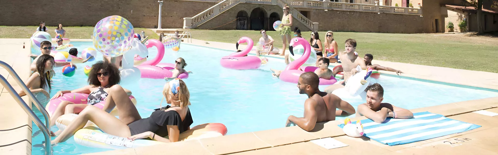 Friends In Swimming Pool Enjoying Sunny Day