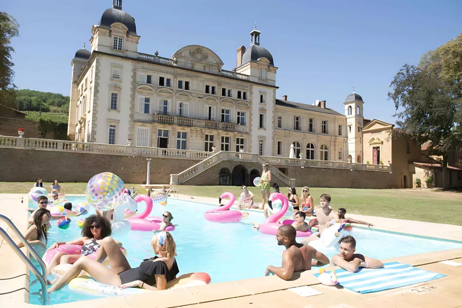 Friends In Swimming Pool Enjoying Sunny Day
