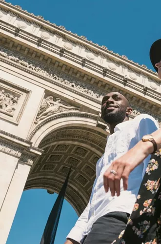 Contiki travellers visiting the Arc de Triomphe in Paris, France, during the London to Berlin by Train Tour, exploring iconic European landmarks and city sights