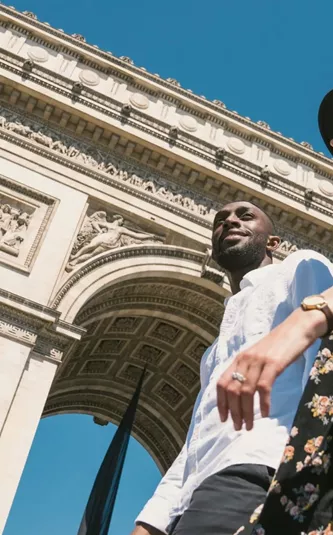 Contiki travellers visiting the Arc de Triomphe in Paris, France, during the London to Berlin by Train Tour, exploring iconic European landmarks and city sights