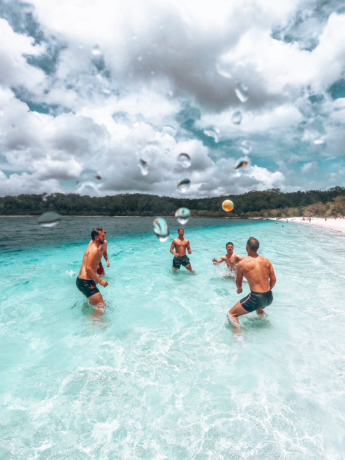 Travellers playing in the clear, shallow waters at K'gari (Fraser Island), Queensland, Australia.