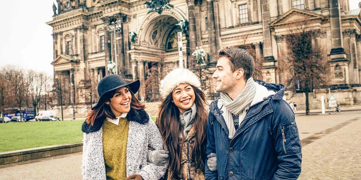 Group Of Young Travelers Exploring Berlin In Winter
