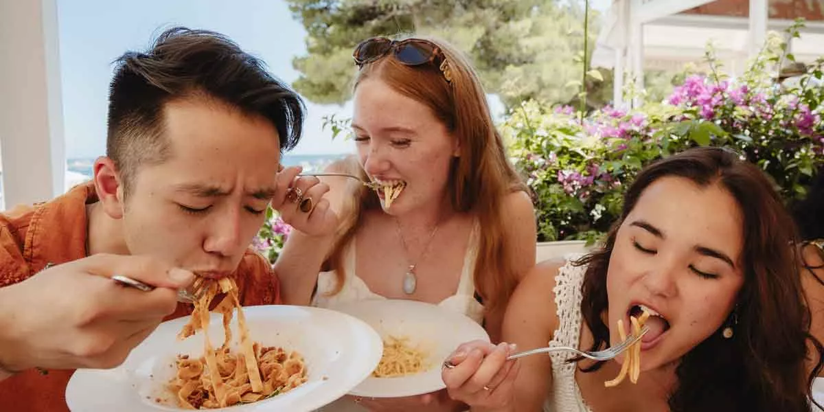 Travelers Enjoying Italian Food In Italy