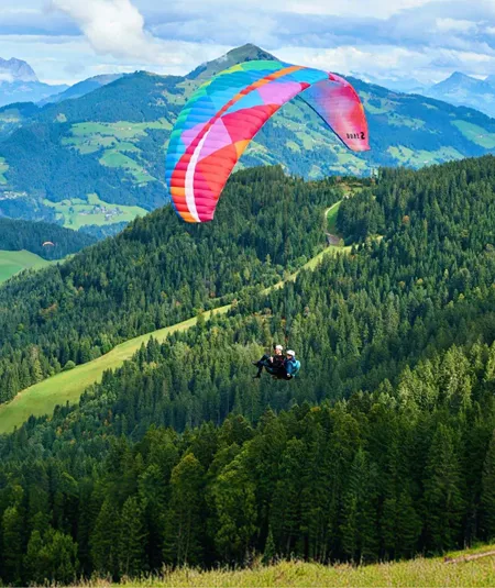 Contiki traveller paragliding over the Austrian Alps on Contiki's Active Alps