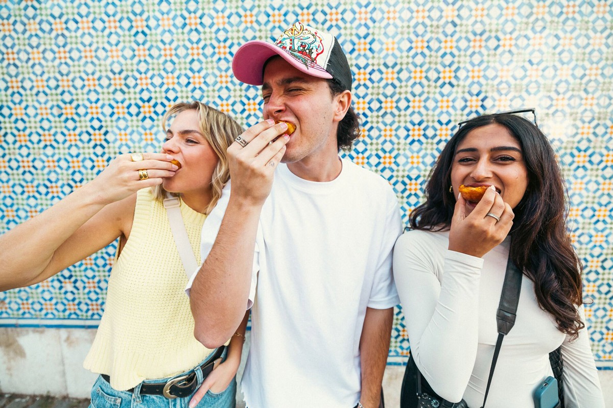 Three Young Friends Enjoying A Dessert in Portugal.