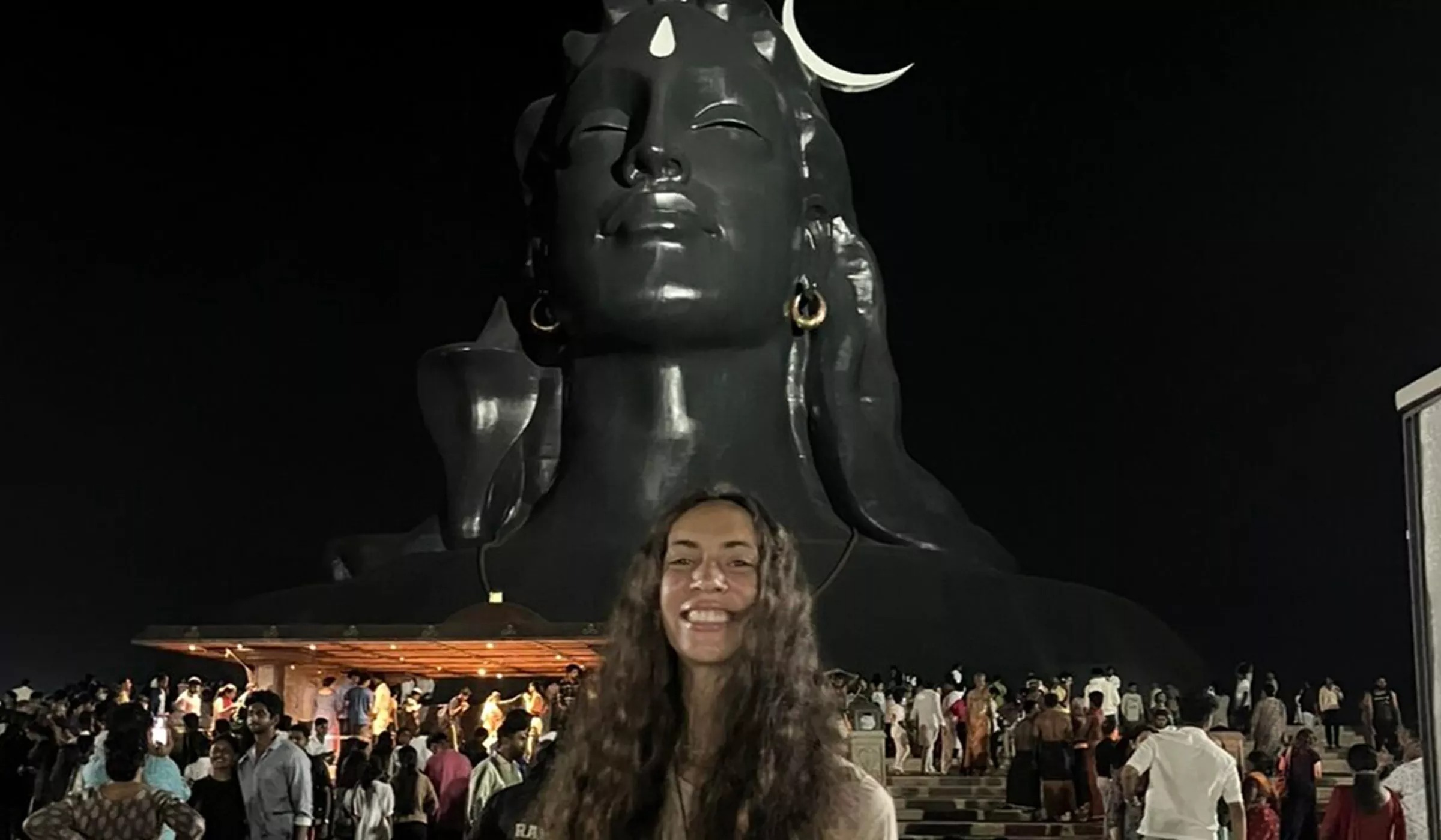 Woman Standing In Front Of Statue