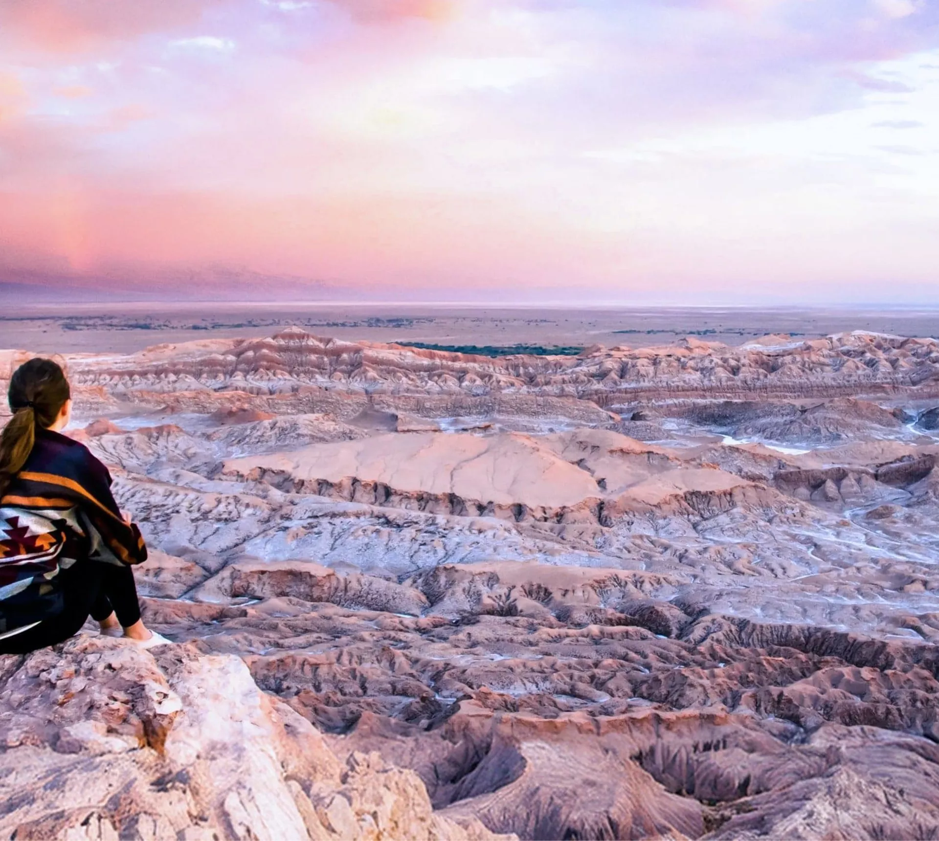Traveller overlooking the otherworldly landscapes of Valle de la Luna in Chile's Atacama Desert at sunset on Contiki's La Paz to Buenos Aires Tour