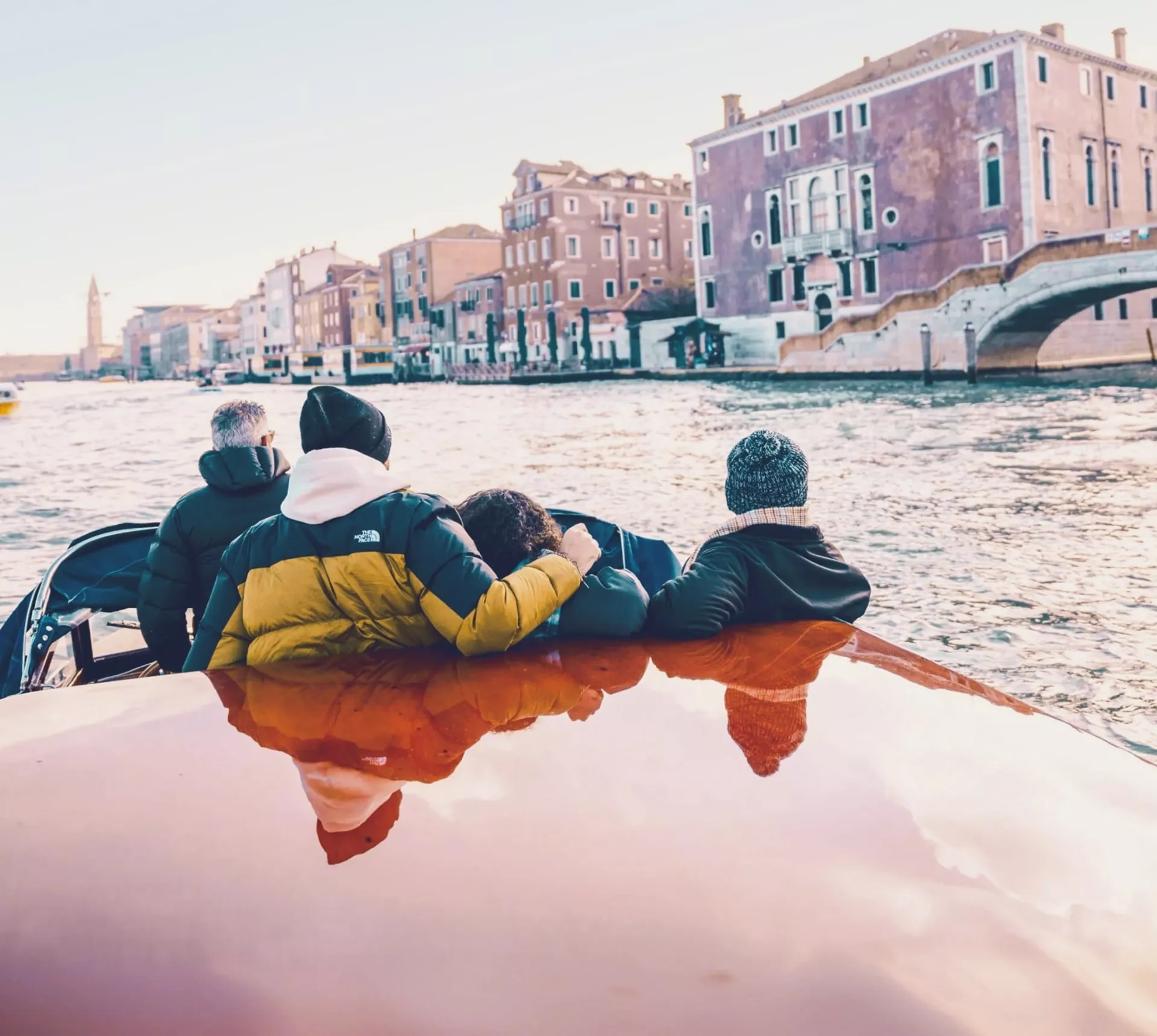 Travellers cruising through Venice by water taxi - Contiki Barcelona to London Quest Tour