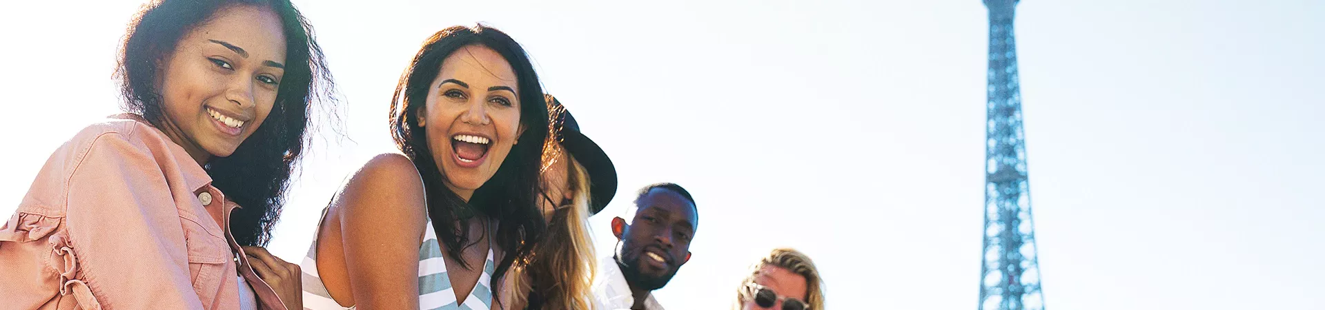 Laughing people posing for a photo with the Eiffel Tower