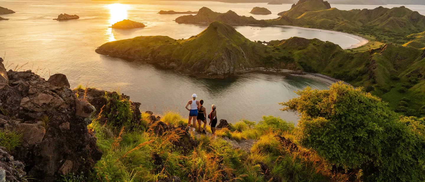 three people looking at sunset