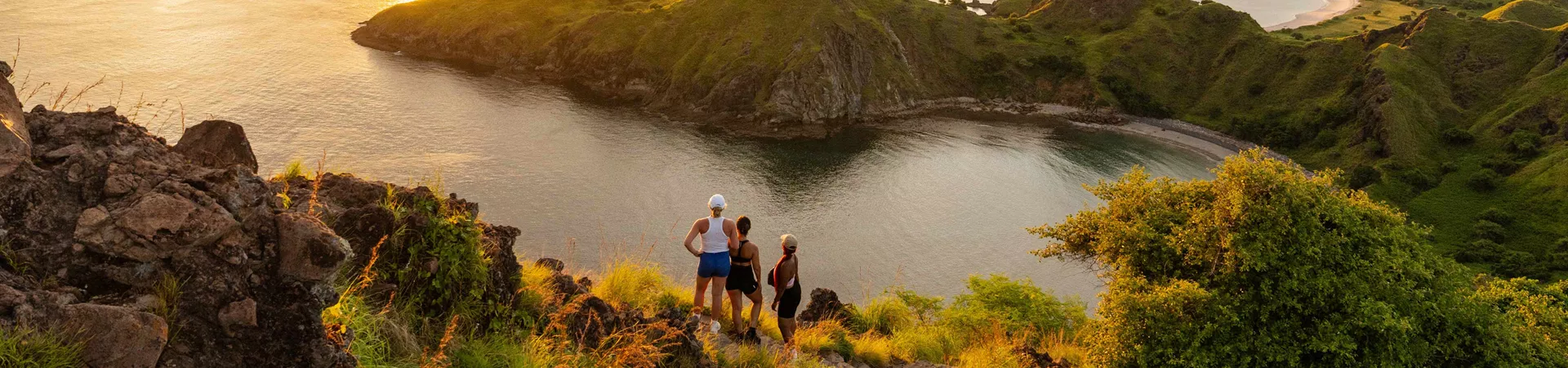 three people looking at sunset