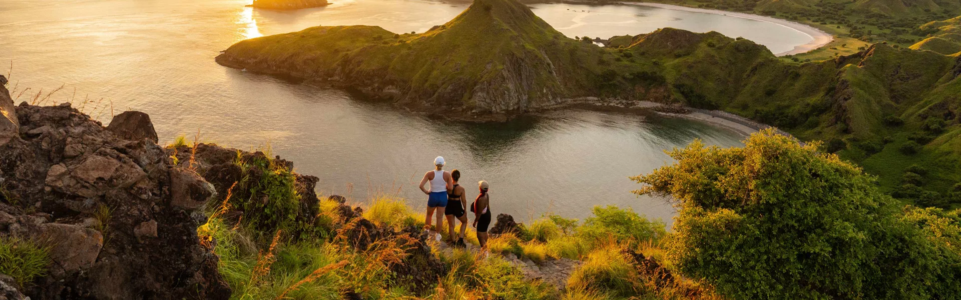three people looking at sunset