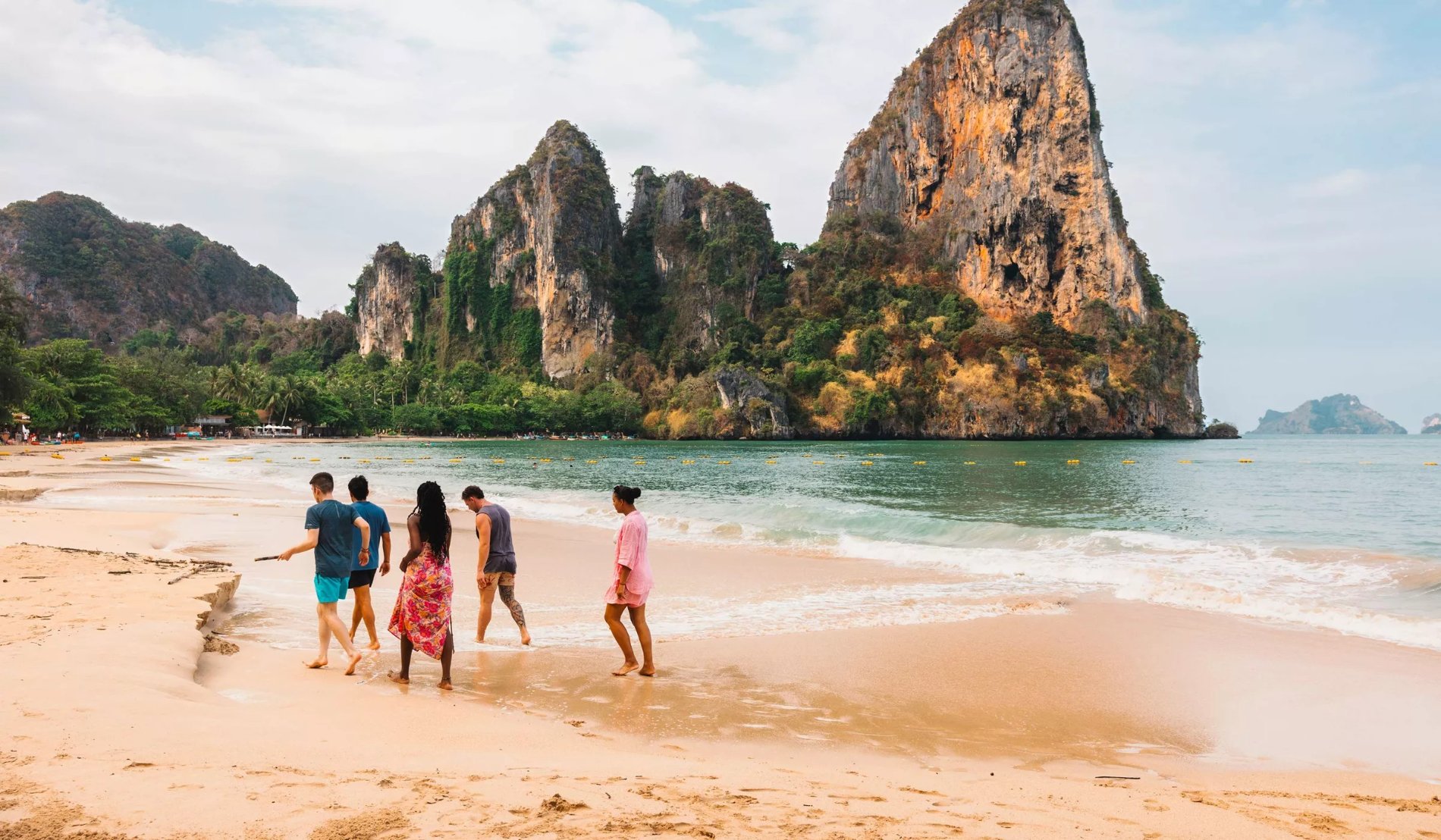 Group of travelles Walking on Thai Beach