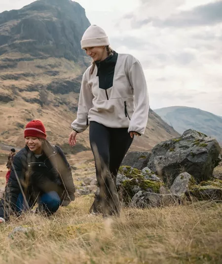 Two people walking through Glencoe in the Scottish Highlands - Contiki Best of Scotland & Ireland Tour
