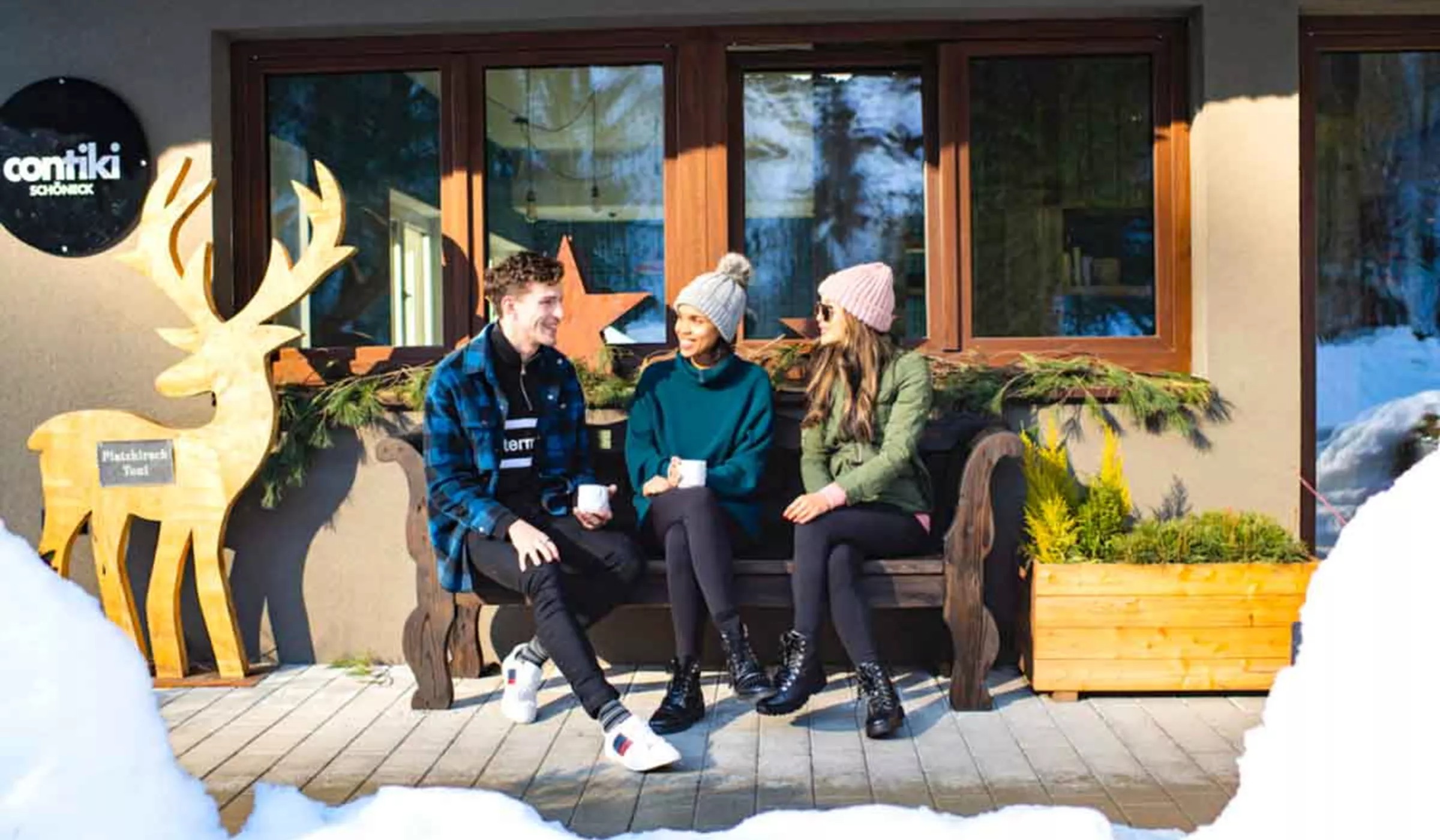 Young Travelers Sitting Bench In Snow Austria