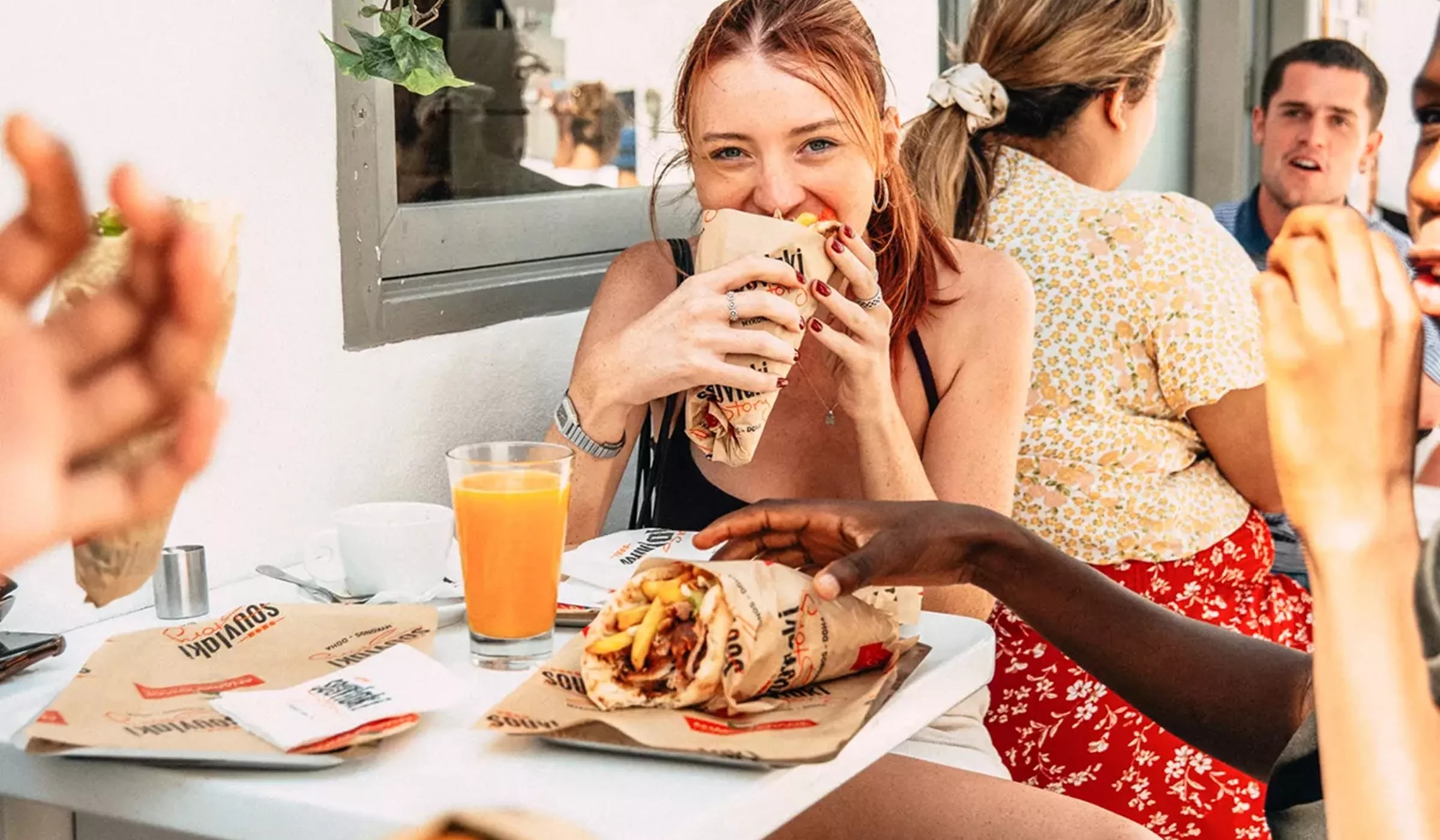 Young Woman Enjoyingl Greek Food
