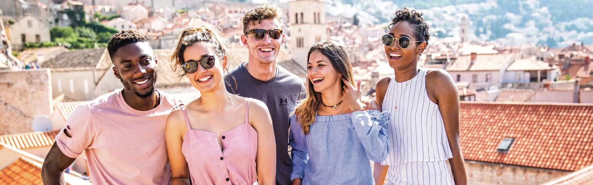 Group of Travelers In The Sun Over Dubrovnik Rooftops