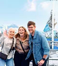 Three Travellers Smiling for Photo at Harbour in San Francisco, USA