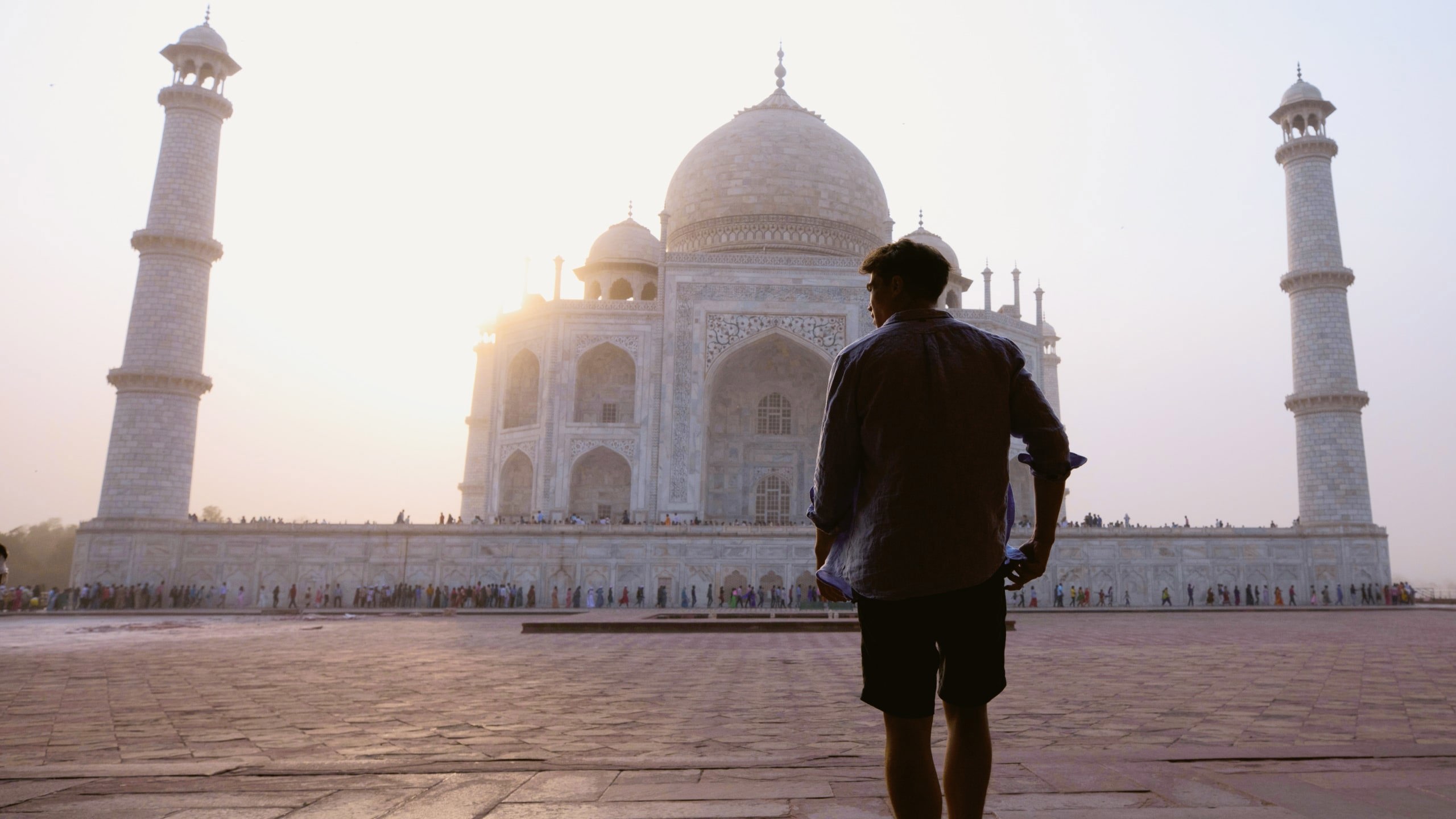 Sunrise illuminates the Taj Mahal as a Contiki traveller takes in India's most iconic monument on the Rajasthan & Golden Triangle Tour