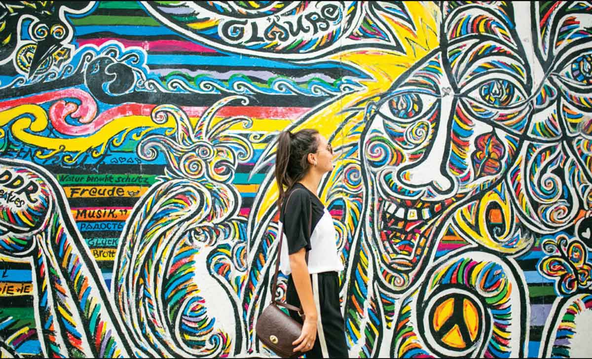 female-traveler-exploring-graffiti-on-city-break.jpg