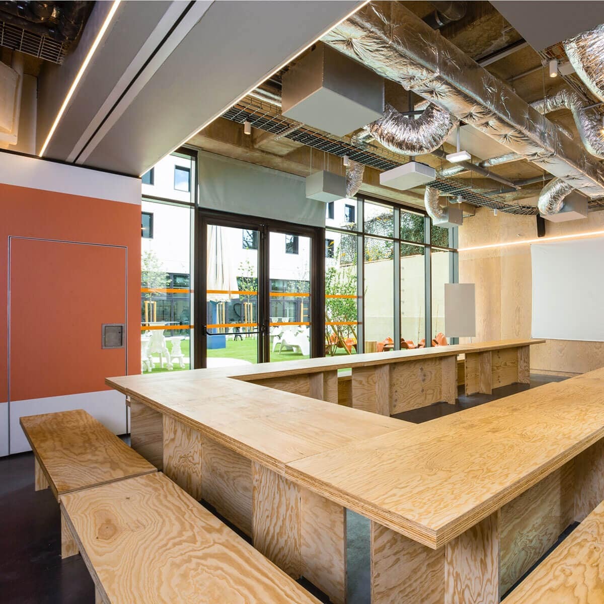 Jo&Joe Hostel conference room with wooden tables and benches
