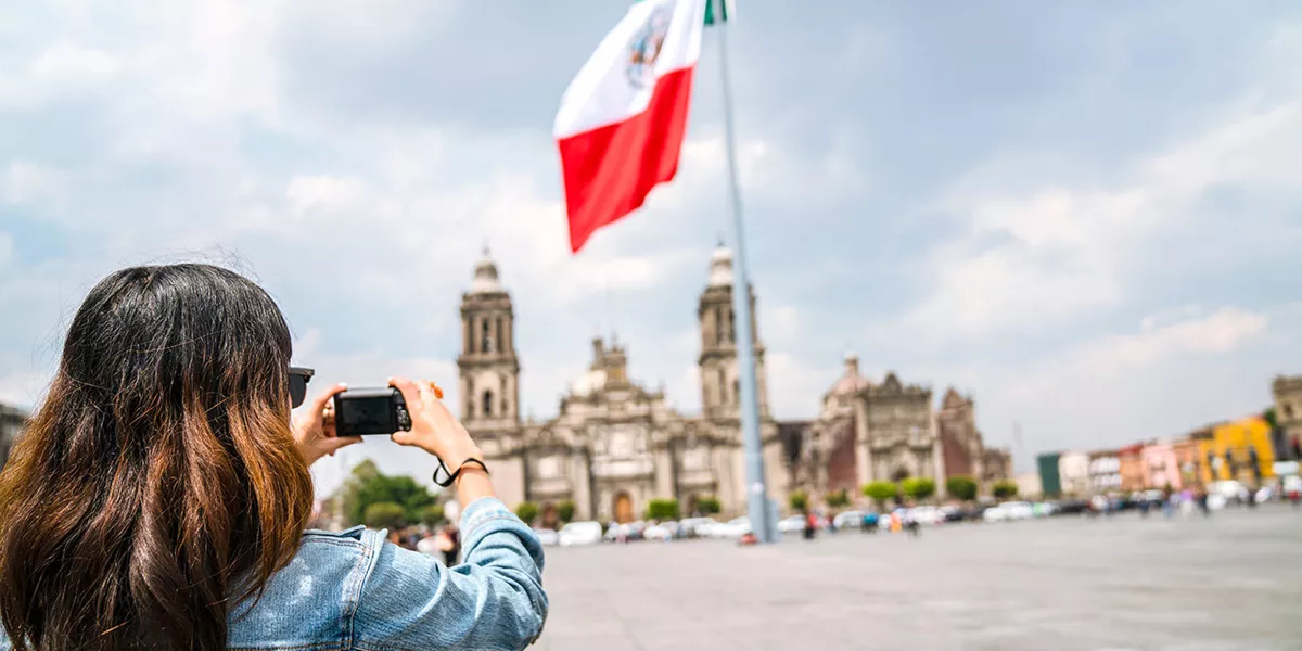 Traveller takes photo of Mexican flag in Mexico City's Zócalo, Mexico