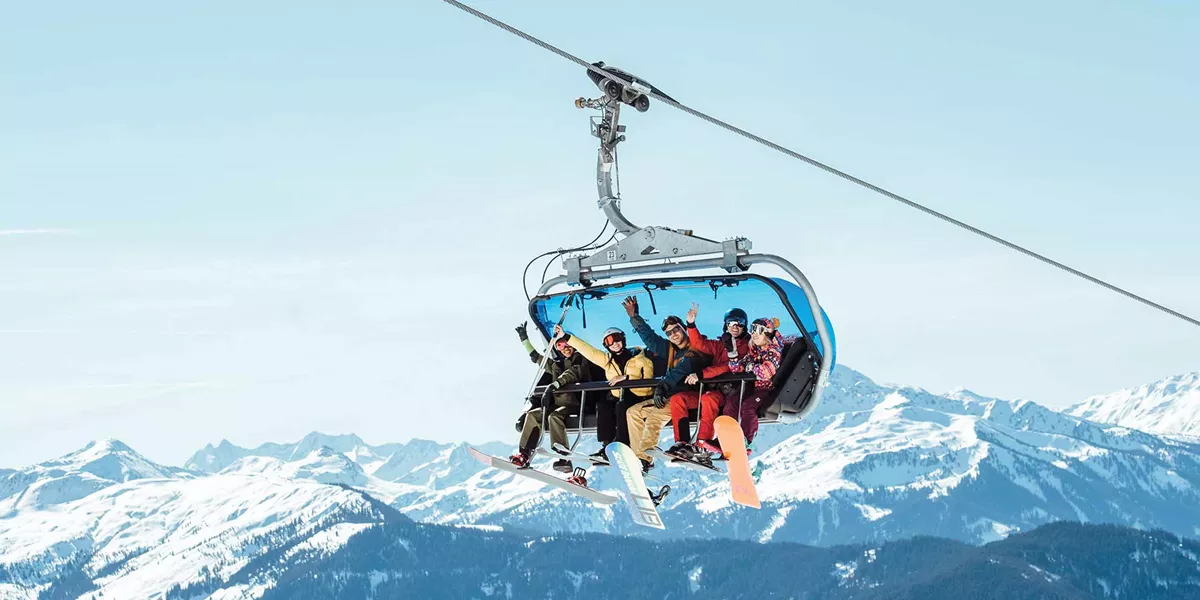 People Going up the Ski Lift and Waving