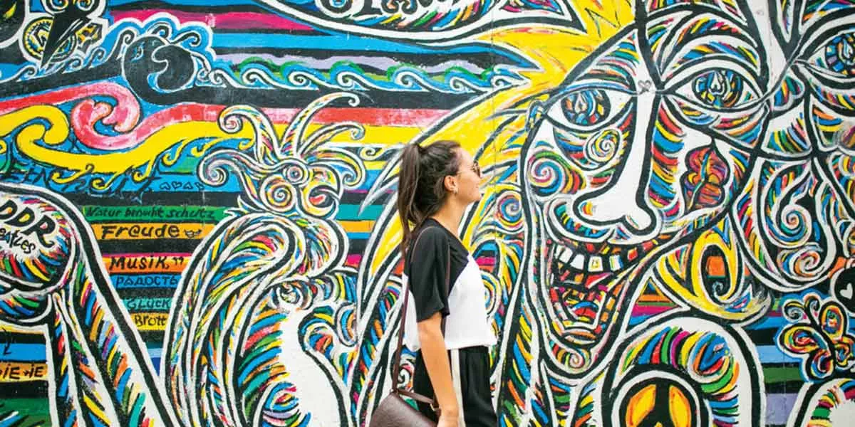 Female Traveler Exploring Graffiti On City Break