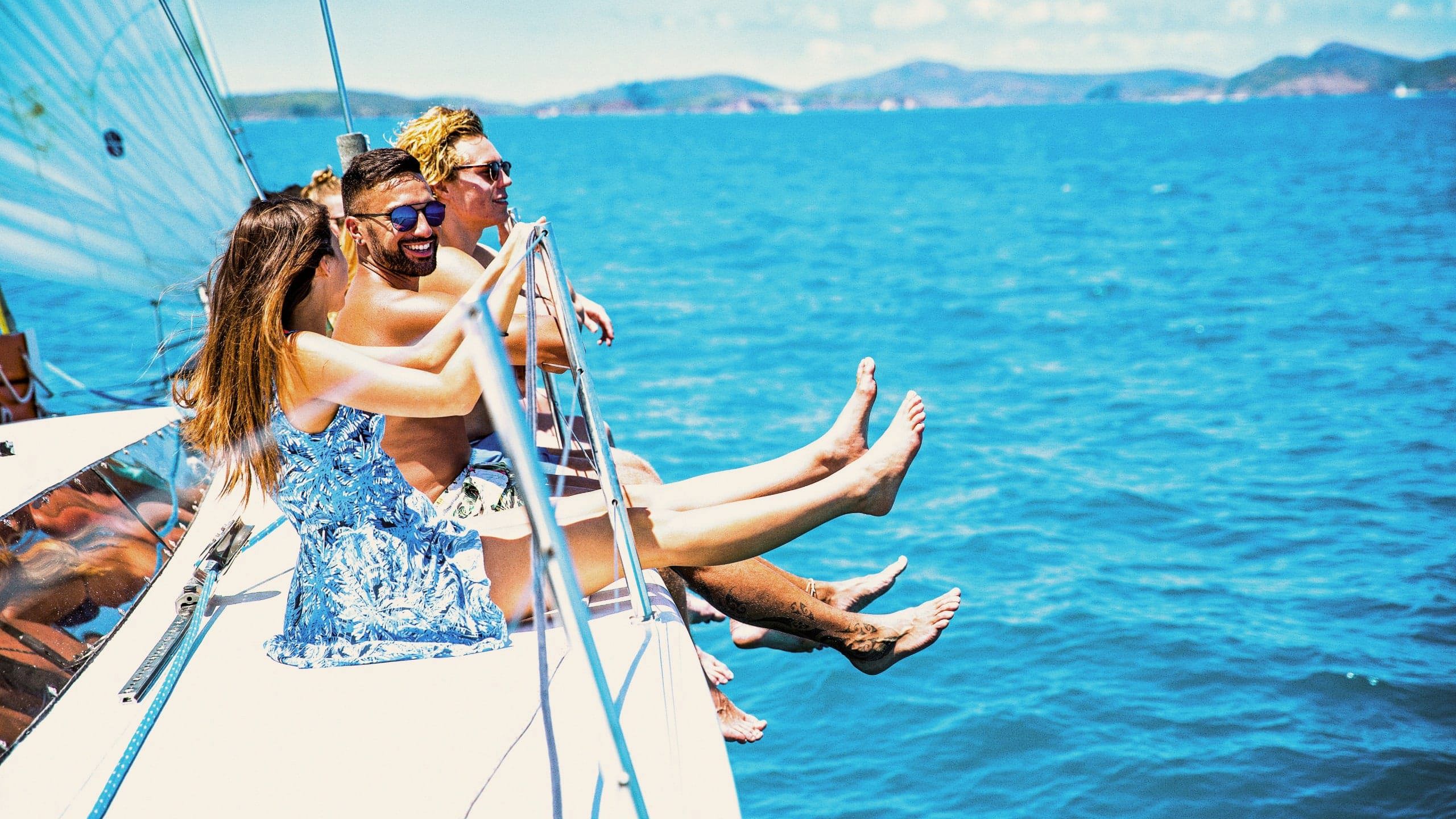 Turquoise waters, island views and a yacht under sail - Contiki travellers cruise through the Whitsundays on the journey to Cairns