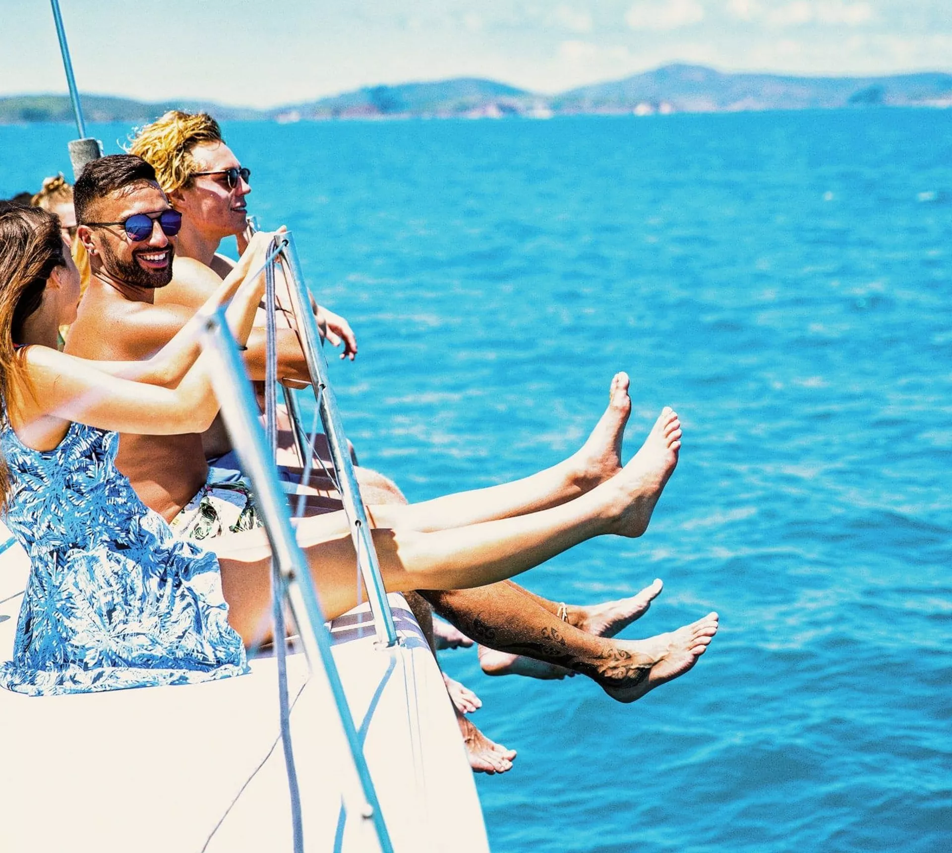 Turquoise waters, island views and a yacht under sail - Contiki travellers cruise through the Whitsundays on the journey to Cairns