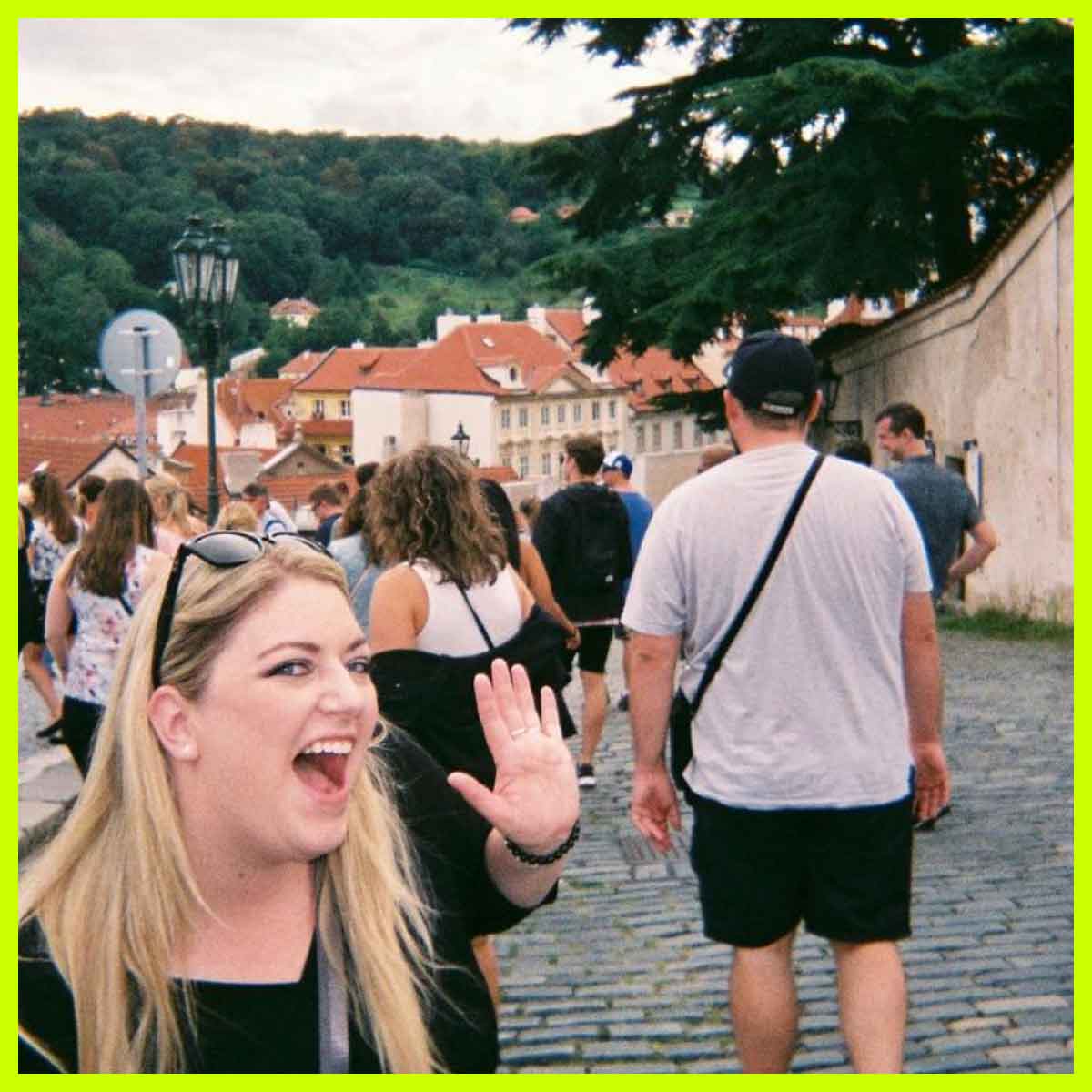 Traveller waving at camera on a street in Prague, Czech Republic