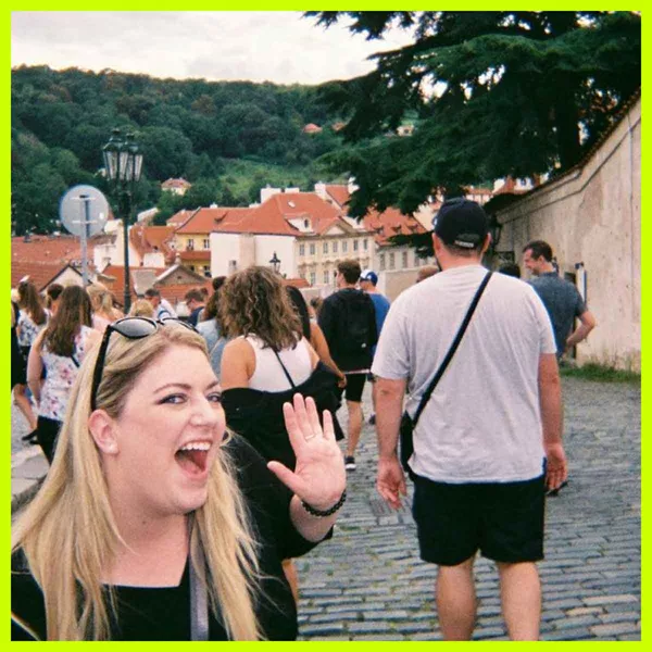 Traveller waving at camera on a street in Prague, Czech Republic