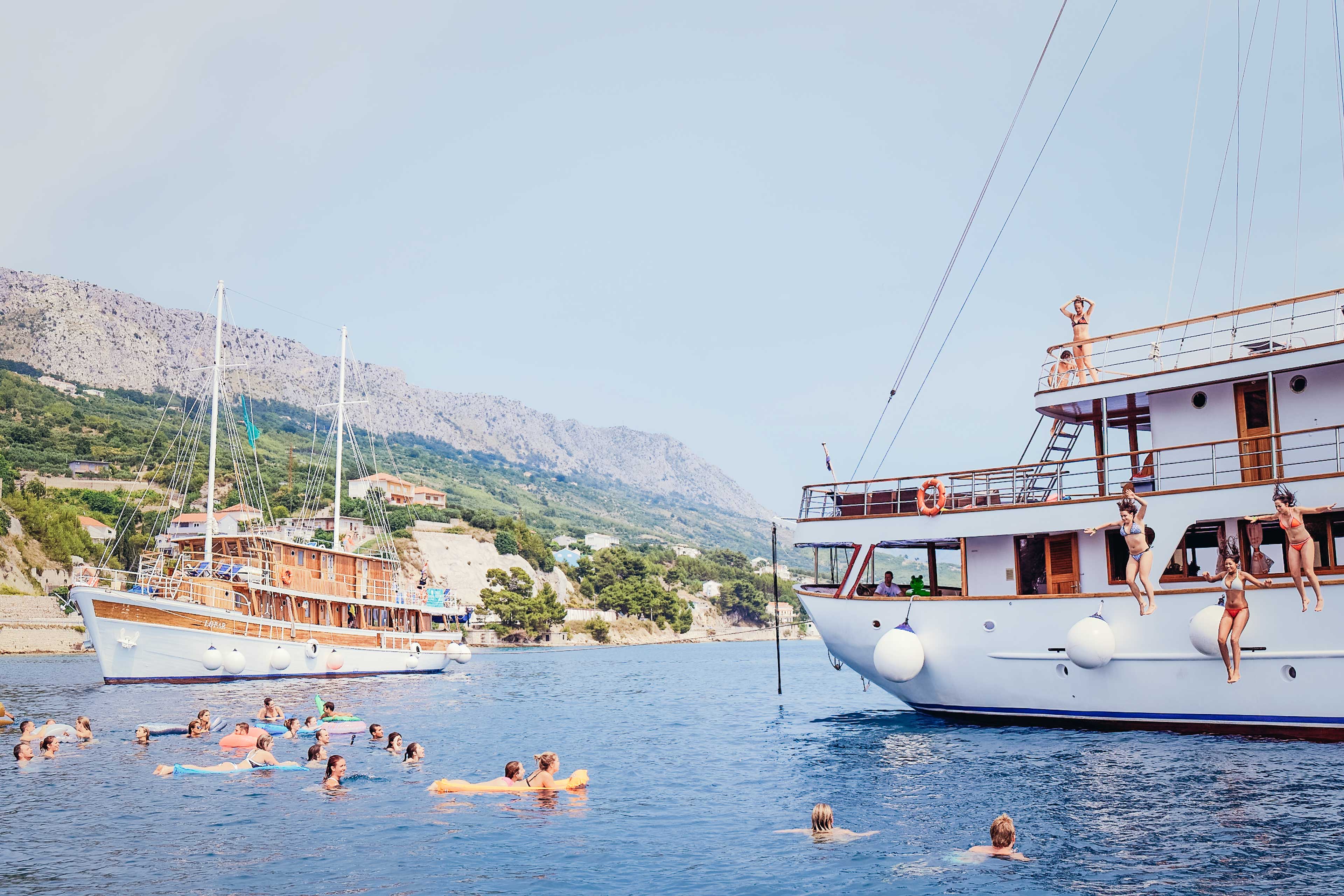 People Enjoying A Boat Trip Clear Blue Water Sunny Day