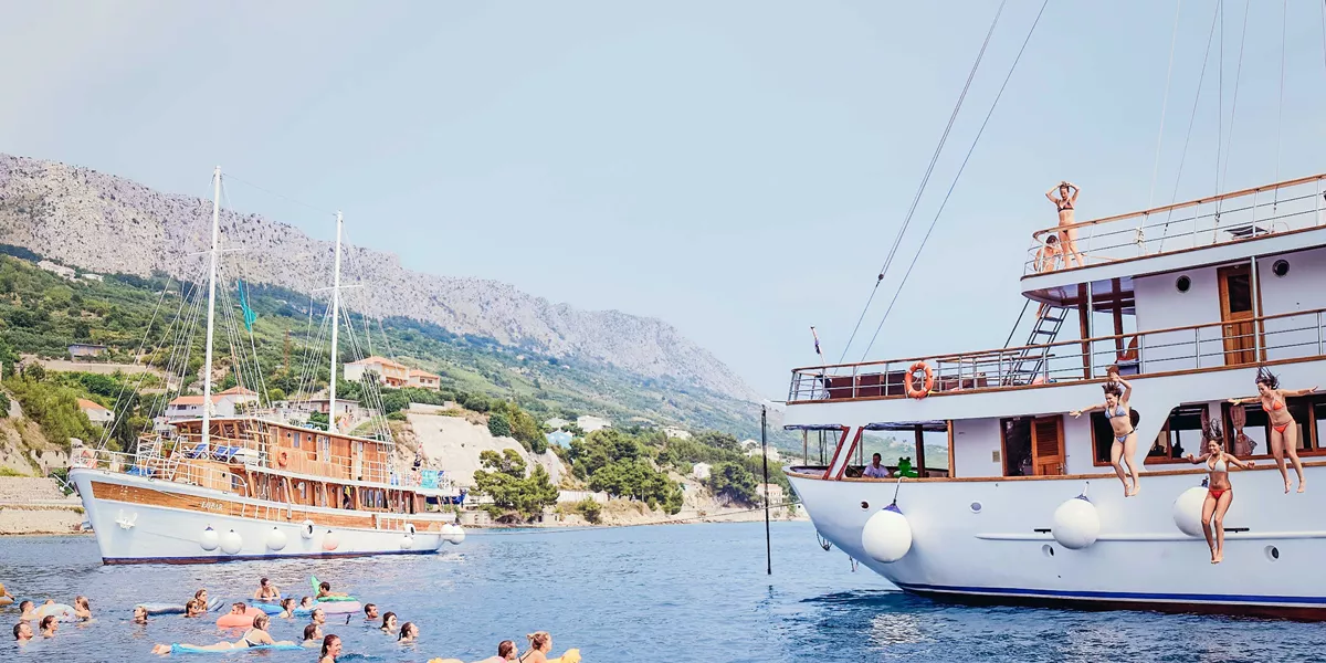 People Enjoying A Boat Trip Clear Blue Water Sunny Day