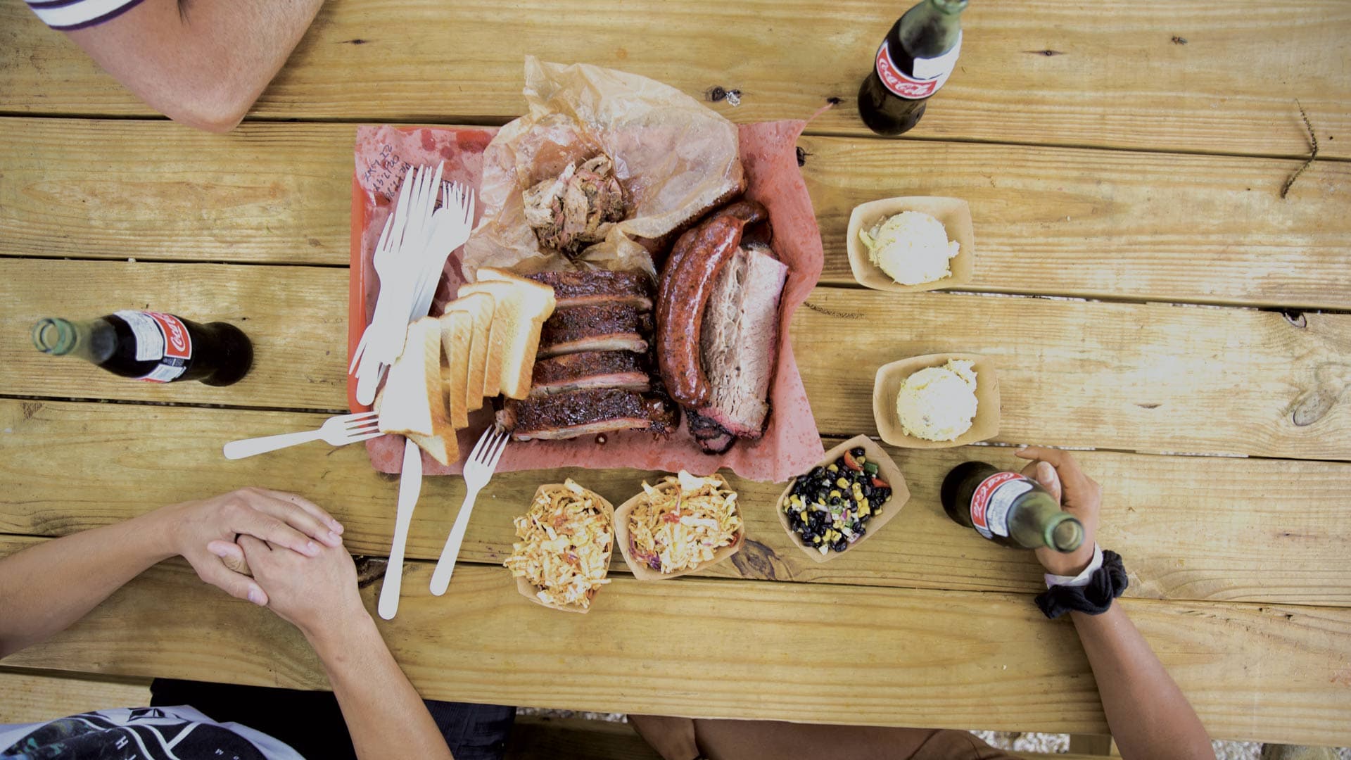Plate with meat breakfast and side dishes on wooden table