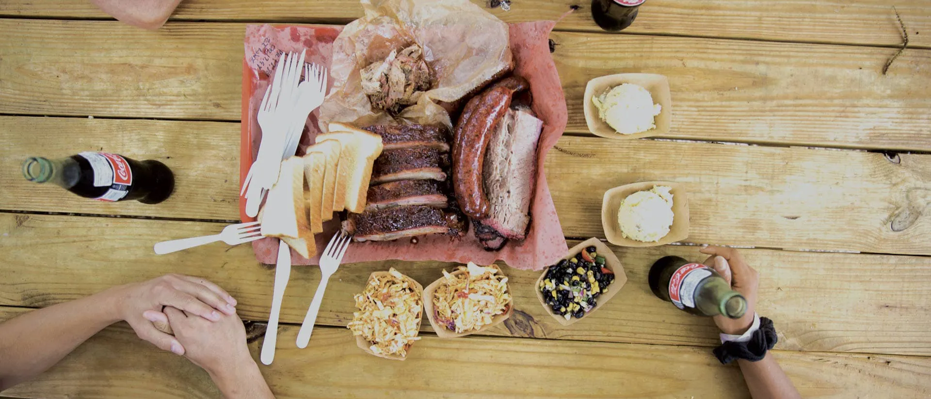 Plate with meat breakfast and side dishes on wooden table