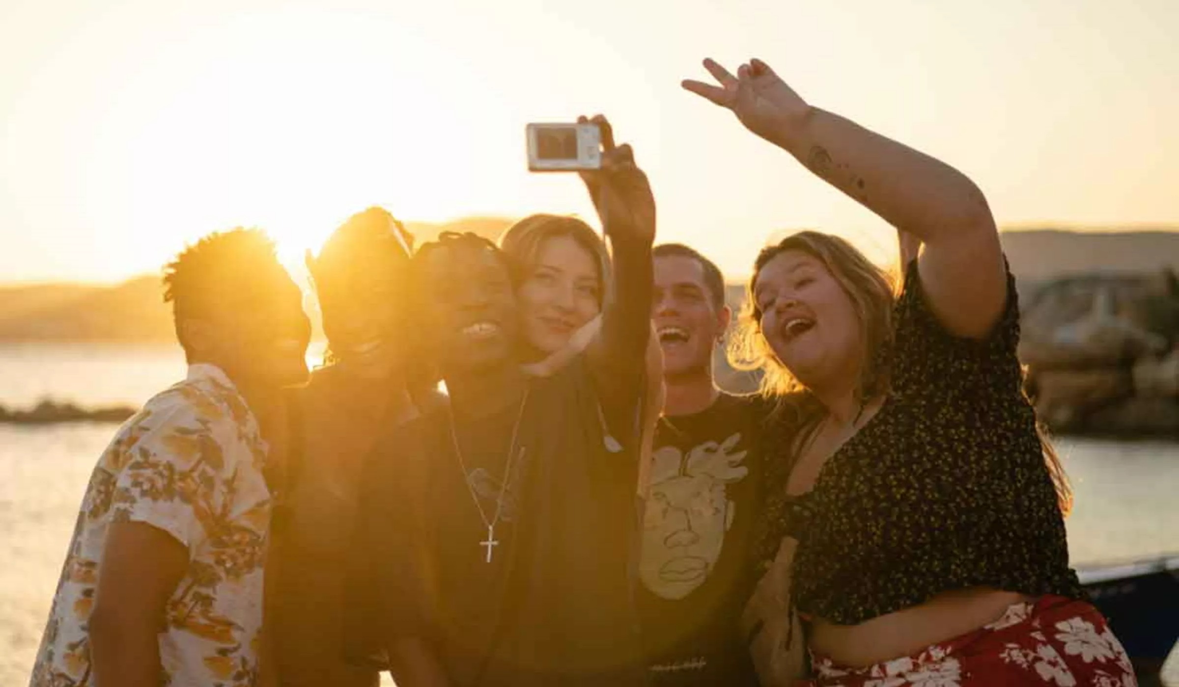 group-taking-selfie-at-sunset.jpg