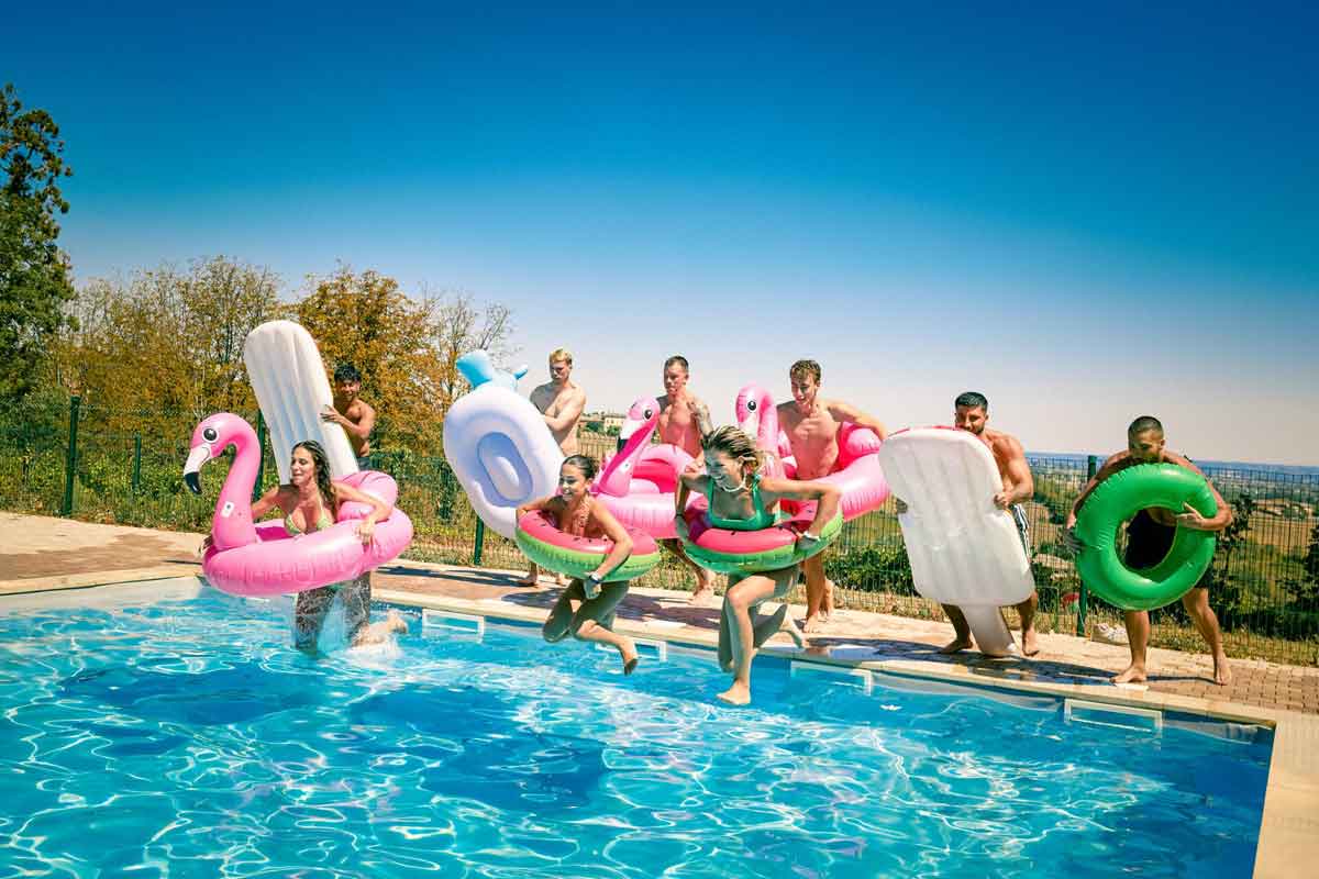Group Of Young Travelers Jumping In Pool With Inflatibiles France 2984EURS2022