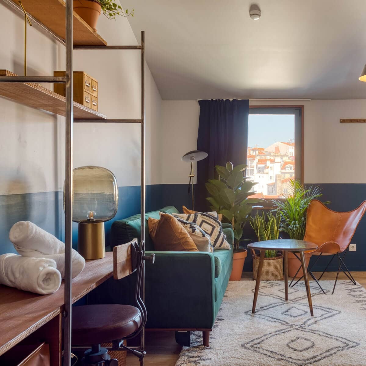 Couch with pillows near window in the room