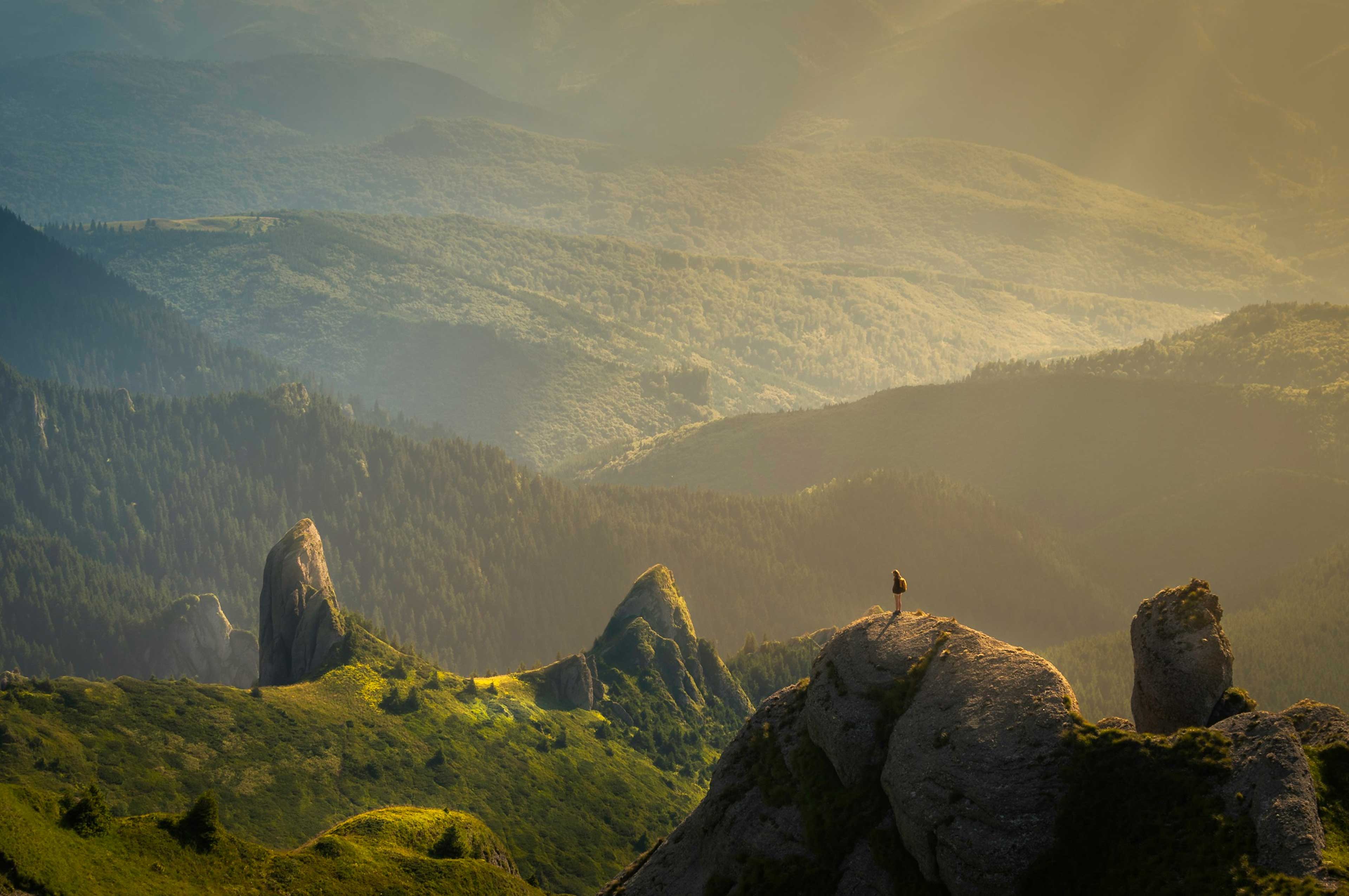 person-standing-on-edge-of-cliff-in-front-of-vast-landscape.jpg