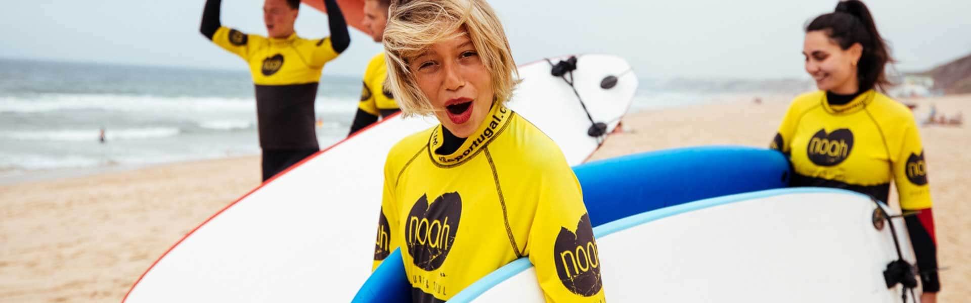A boy with a funny expression holding a paddleboard