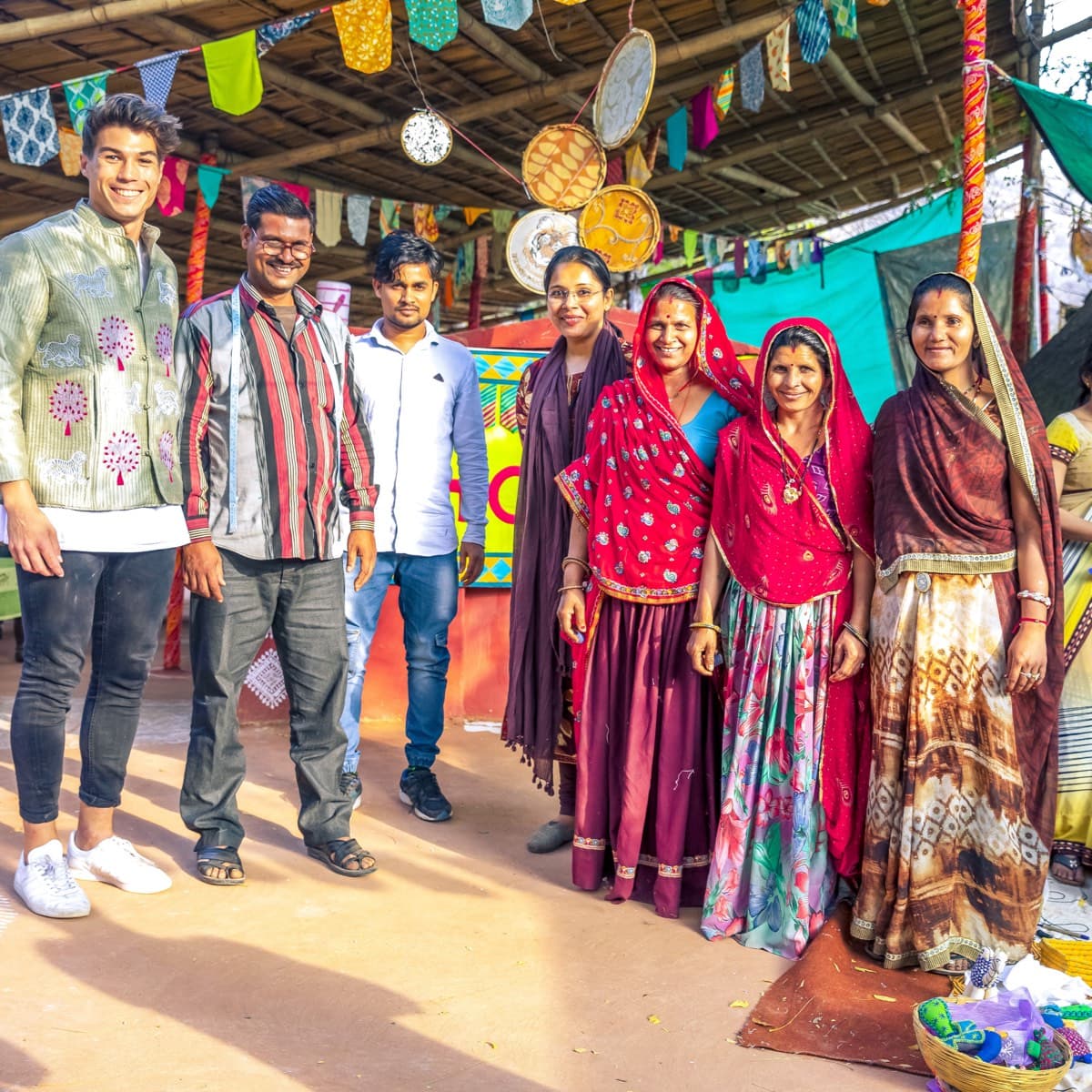 A group of Indian people standing next to each other at a market