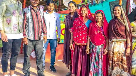 A group of Indian people standing next to each other at a market